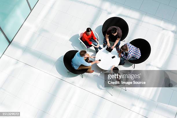 overhead view of colleagues in meeting - cinco pessoas imagens e fotografias de stock