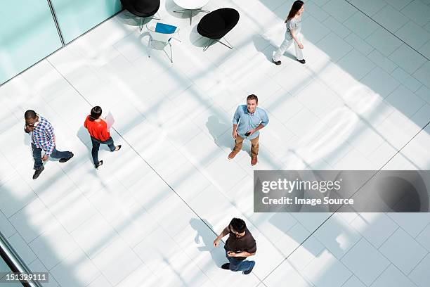 man standing on office concourse - looking up ストックフォトと画像
