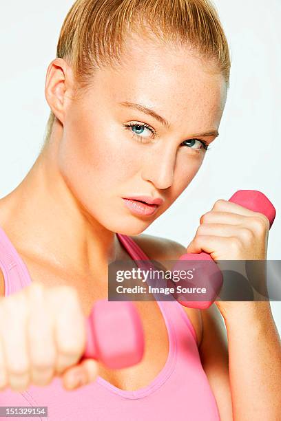 young woman using hand weights - hand weight ストックフォトと画像