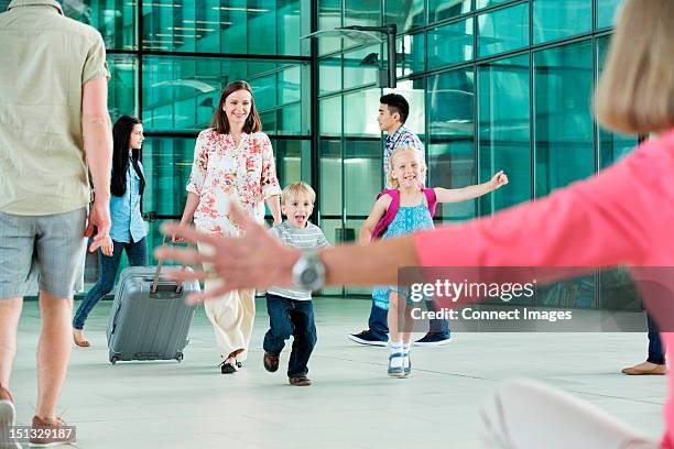 children running excitedly towards grandmother - reunion stock pictures, royalty-free photos & images