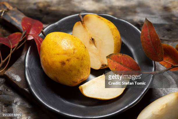 there is a pear cut in half, slices - half complete stock pictures, royalty-free photos & images