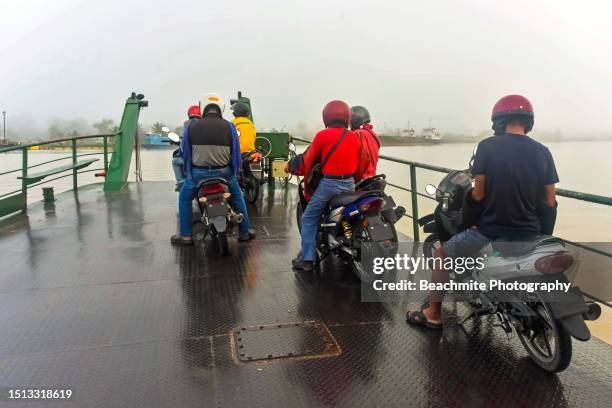 sibu, sarawak, malaysia : july 1 2023 early morning view of passengers on a ferry crossing the mighty rajang river, the longest river in malaysian borneo. - sibu river stock pictures, royalty-free photos & images