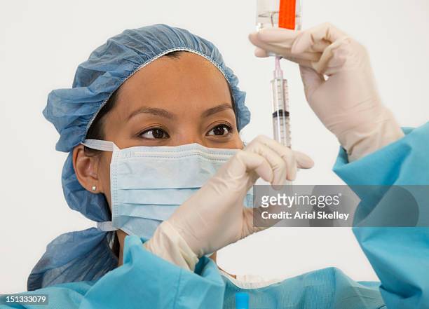 asian doctor filling syringe - ariel shot stockfoto's en -beelden