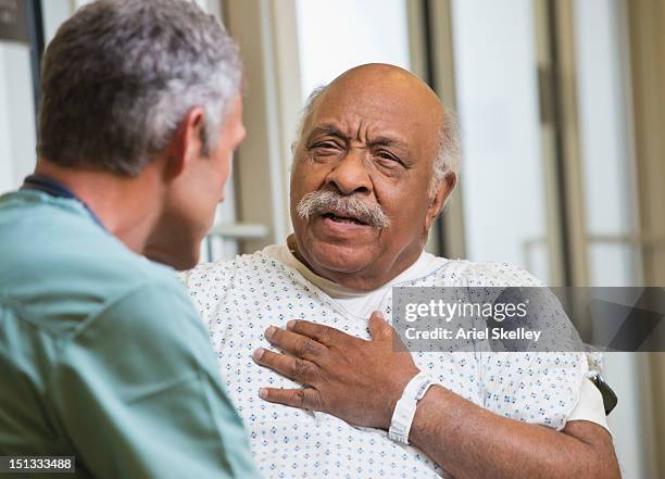 doctor talking to patient in hospital - cardiologist bildbanksfoton och bilder