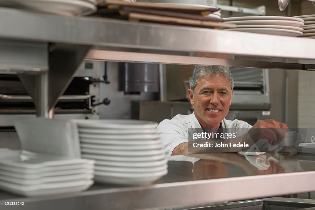 Caucasian chef standing in commercial kitchen