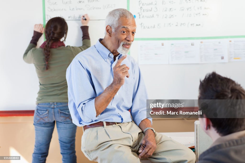 Teacher and students talking in classroom