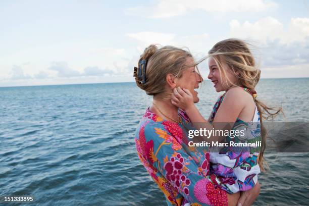 caucasian mother and daughter enjoying the beach - beach florida family stockfoto's en -beelden