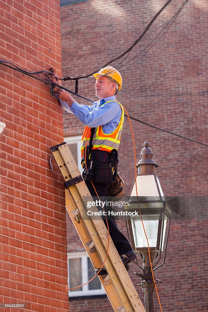 Cable Lineman Installing Wires From His Ladder High-Res Stock Photo ...