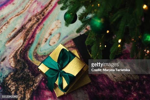 gift on the floor on the carpet. new year. christmas. - 2019 gold stock pictures, royalty-free photos & images
