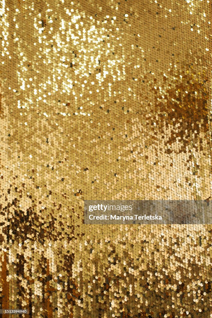 Background with gold sequins. Festive background. Christmas. New Year.