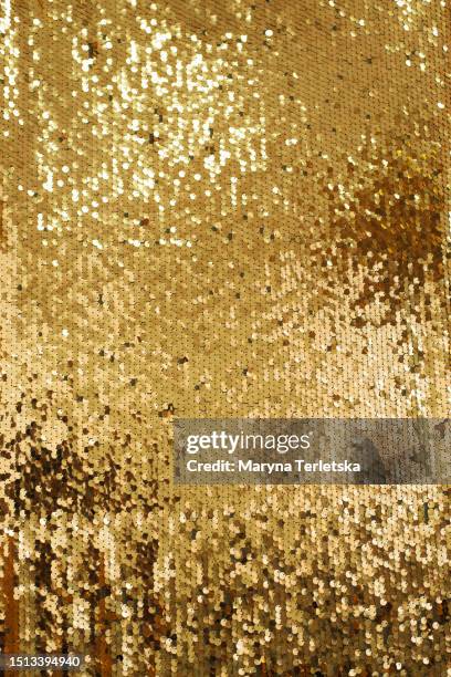 background with gold sequins. festive background. christmas. new year. - metallic dress stock pictures, royalty-free photos & images