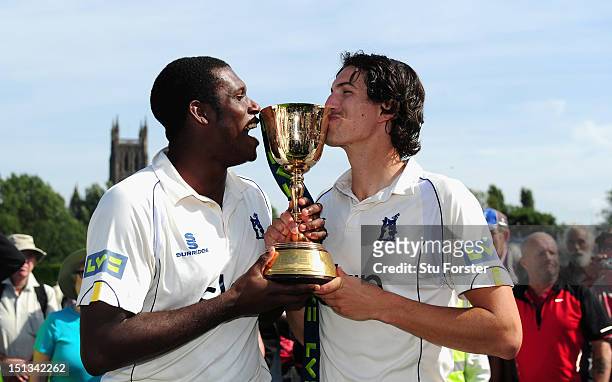 Warwickshire bowlers Keith Barker and Chris Wright kiss the trophy after winning the LV County Championship Division One title after day three of the...