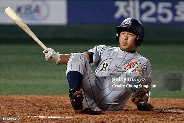 Tatsuhiro Tamura of Japan falls during the match between Japan and South Korea on day two of the U18 Baseball World Championship at Mokdong Stadium...