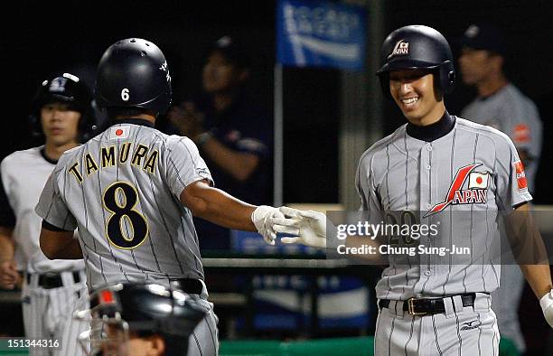 Tatsuhiro Tamura of Japan is congratulated by Gen Mizumoto during the match between Japan and South Korea on day two of the U18 Baseball World...