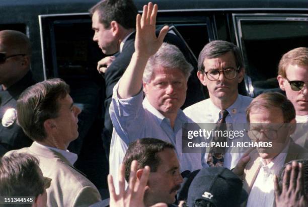 President Bill Clinton waves to residents 19 January 1994 during a tour of earthquake stricken areas near Los Angeles, CA. Clinton toured damaged...