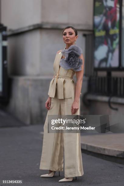 Svitlana Degtyarenko seen outside Georges Hobeika show wearing long golden earrings, golden shiny Fendi suit with a logo Fendi belt combined with a...