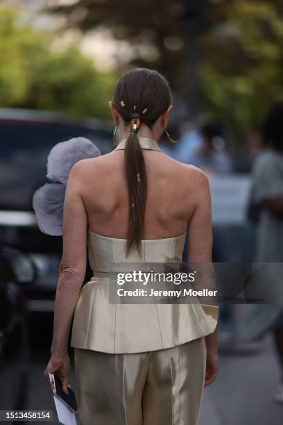 Svitlana Degtyarenko seen outside Georges Hobeika show wearing long golden earrings, golden shiny Fendi suit with a logo Fendi belt combined with a...