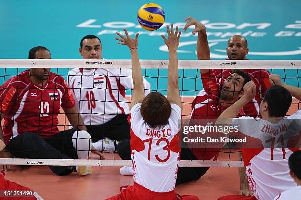 China's Xiaochao Ding attempts to block a shot by Hesham Abdelmaksod of Egypt during the men's Sitting Volleyball 5-8 Clasification match on day 8 of...