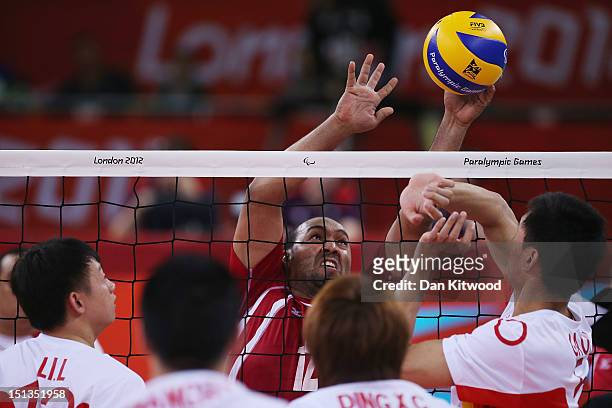 China attempt to block a shot by Mohamed Ibrahim of Egypt during the men's Sitting Volleyball 5-8 Clasification match on day 8 of the London 2012...