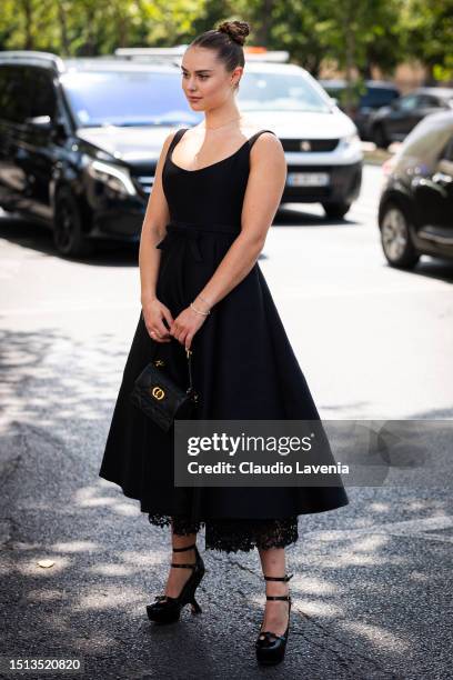 Margo Hayes wears a black midi skirt, black Dior bag and heels, outside Dior, during the Haute Couture Fall/Winter 2023/2024 as part of Paris Fashion...