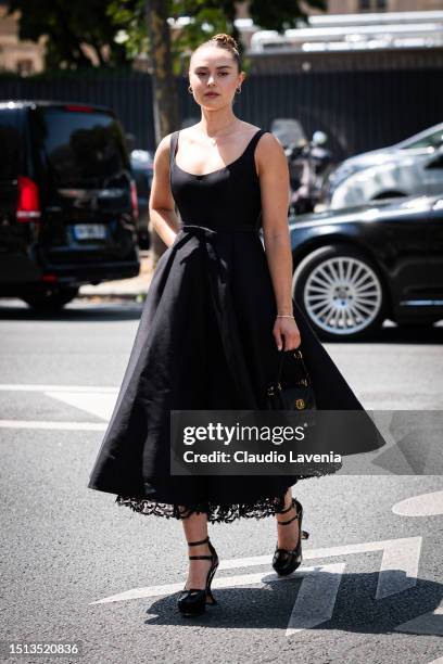 Margo Hayes wears a black midi skirt, black Dior bag and heels, outside Dior, during the Haute Couture Fall/Winter 2023/2024 as part of Paris Fashion...