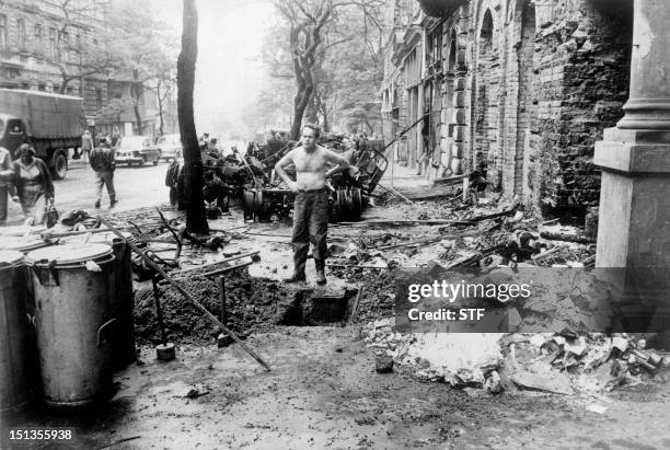 File photo dated 31 August 1968 of man standing amidst the damages caused by the confrontations between demonstrators and the Warsaw Pact troops and...