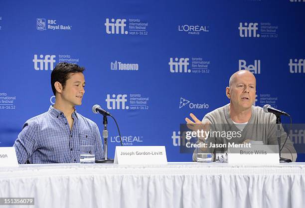 Actors Joseph Gordon-Levitt and Bruce Willis speak onstage at the "Looper" press conference during the 2012 Toronto International Film Festival at...