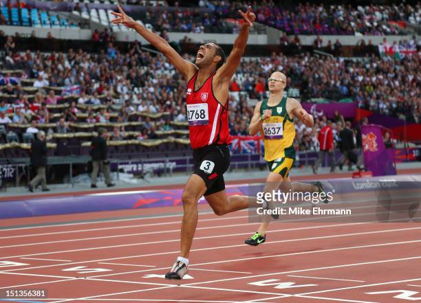 Mahmoud Khaldi of Tunisia crosses the line ahead of to win gold Hilton Langenhoven of South Africa in the Men's 400m - T12 Final on day 8 of the...