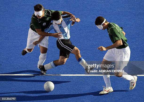 Argentina's Lucas Rodriguez gets tackled by Brazil's Ricardo Steinmetz Alvares during the men's 5-a-side football semi-final match between Argentina...