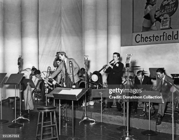 Glenn Miller and members of his orchestra perform with the Glenn Miller Orchestra for CBS radio at the Chesterfield Radio Playhouse in Times Square...