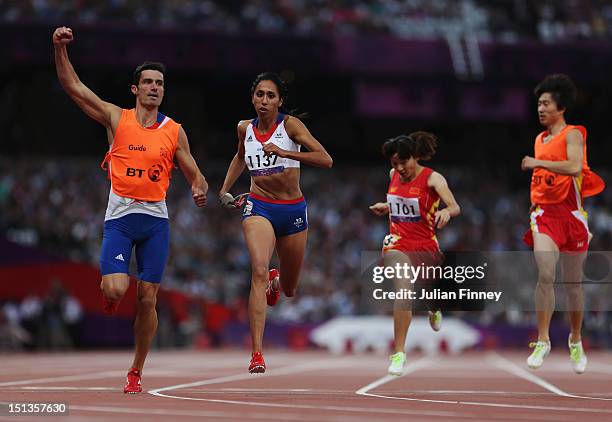 Assia El Hannouni of France and her guide Gautier Simounet cross the line to win gold in the Women's 200m - T12 on day 8 of the London 2012...