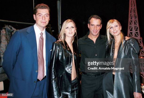 Mario Maccioni, Paris Hilton, designer Lloyd Klein, and Nicky Hilton celebrate backstage after Lloyd Klein's presentation of his fall/winter 2001...