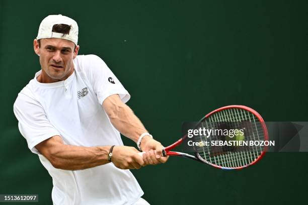 Player Tommy Paul returns the ball to Czech Repbulic's Jiri Vesely during their men's singles tennis match on the sixth day of the 2023 Wimbledon...