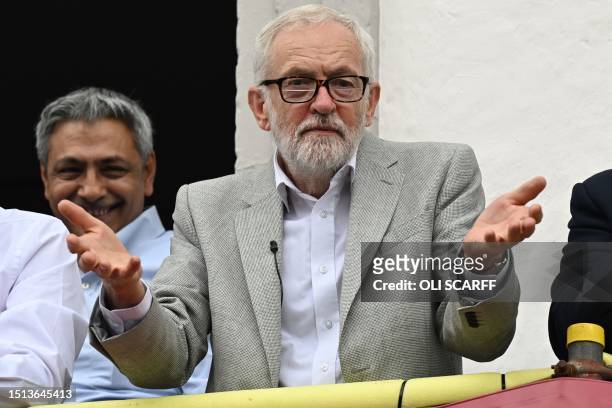 Former leader of the Labour Party, Jeremy Corbyn gestures from the balcony of the Royal County hotel as trade union supporters march past during the...