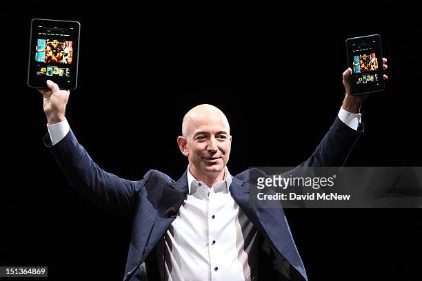 Amazon CEO Jeff Bezos holds up the new Kindle Fire HD reading device in two sizes during a press conference on September 6, 2012 in Santa Monica,...