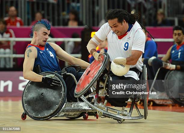Riadh Sallem of France is challenged by David Anthony of Great Britain during the Wheelchair Rugby Pool Phase Group A match between Great Britain and...