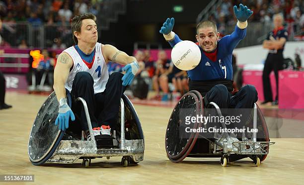 Mike Kerr of Great Britain reaches out to get the ball before Sebastien Lhuissier of France during the Wheelchair Rugby Pool Phase Group A match...