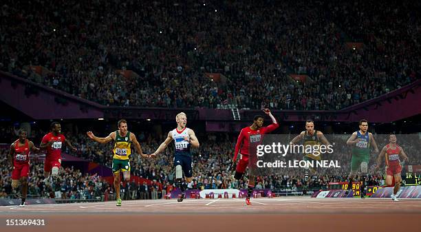 Britain's Jonnie Peacock crosses the line first to win ahead of US athlete Jerome Singleton, US athlete Blake Leeper, South Africa's Arnu Fourie, US...