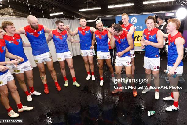 Demons players sing the team song during the 2023 AFL Round 17 match between the St Kilda Saints and the Melbourne Demons at Marvel Stadium on July...