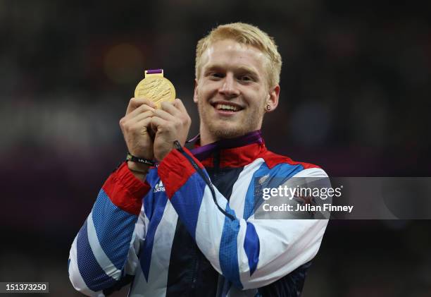 Gold medalist Jonnie Peacock of Great Britain poses on the podium during the victory ceremony for the Men's 100m - T44 on day 8 of the London 2012...