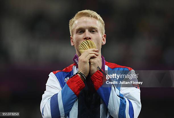 Gold medalist Jonnie Peacock of Great Britain poses on the podium during the victory ceremony for the Men's 100m - T44 on day 8 of the London 2012...