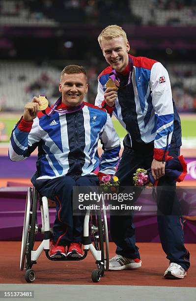 Men's 800m - T54 Gold medalist David Weir of Great Britain and Men's 100m - T44 Gold medalist Jonnie Peacock of Great Britain pose on day 8 of the...