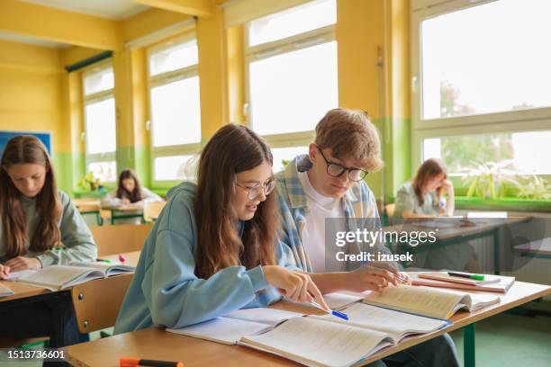 high school students during lesson in the classroom - boy girl stock pictures, royalty-free photos & images
