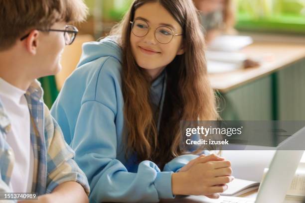 smiling teenage girl during lesson - girls conversation stock pictures, royalty-free photos & images