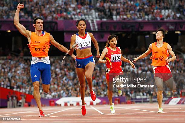 Assia El Hannouni of France and her guide Gautier Simounet cross the line to win gold in the Women's 200m - T12 on day 8 of the London 2012...