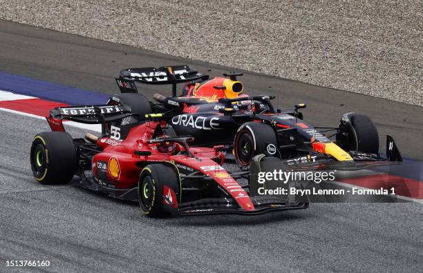 Max Verstappen of the Netherlands driving the Oracle Red Bull Racing RB19 and Carlos Sainz of Spain driving the Ferrari SF-23 battle for track...