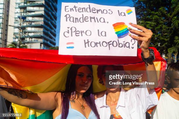 Demonstrators hold sings against homophobia during the international Pride parade in Ibague, Colombia, June 28, 2023.