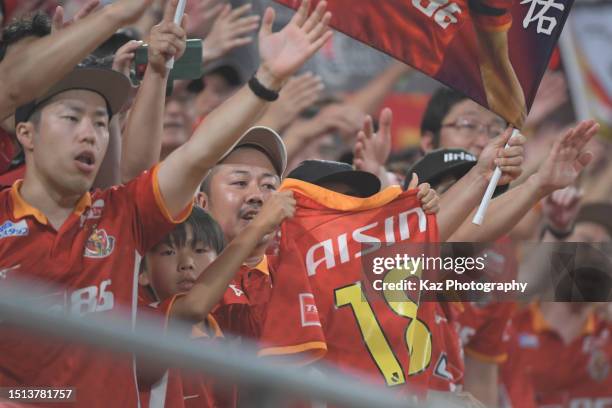 A young Grampus suppoter gets the unifom of Kensuke Nagai of Nagoya GRampus during the J.LEAGUE Meiji Yasuda J1 20th Sec. Match between Nagoya...