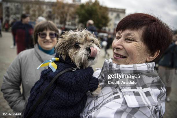 Ukrainian woman celebrates liberation with her dog at Independence Square after the withdrawal of the Russian army from Kherson to the eastern bank...