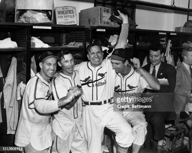 Enos Slaughter, Harry Brecheen, Eddie Dyer and Harry Walker celebrate in the locker rooms during the 1946 World Series held at Sportsman Park, St....